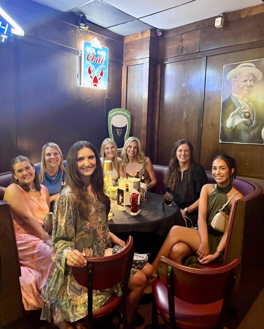 Group of friends at a booth table at Yesterdays Bar & Grill